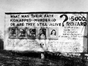 The billboard erected by George and Jennie Sodder along Route 16 in West Virginia in 1952, displaying photographs of the five missing children and offering a reward (initially $5,000, later raised to $10,000) for information. It stood for decades and became one of the most recognizable symbols of the case.